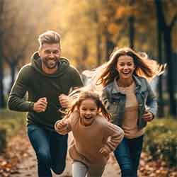 Free Family Image of A Husband and Wife Playing with their Daughter Free Family Image of A Husband and Wife Playing with their Daughter