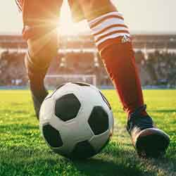 Free Sports Photo of Football Player Shuffling the Ball