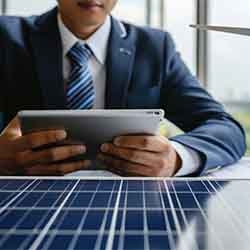 Free Technology Image of a man in formal suit working on iPad